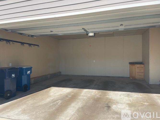 A spacious garage with a concrete floor and a white ceiling.