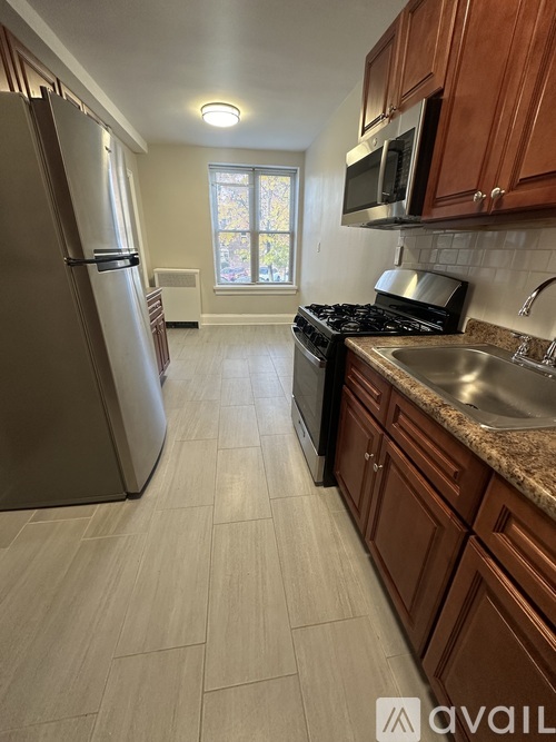A kitchen with a refrigerator, microwave, and stove.