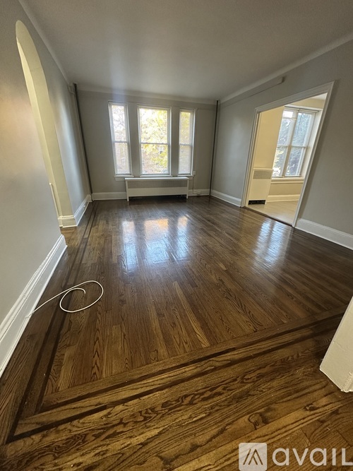 A room with wooden flooring and a window.