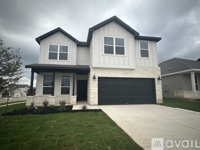 A two-story house with a garage is available for sale.