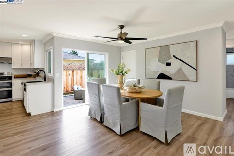 A modern kitchen with a dining table set for four.