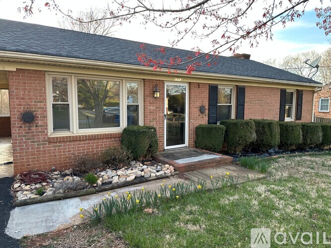 A house with a red brick exterior and a grey roof.