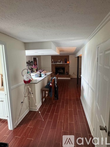 A room with a wooden floor and white walls.