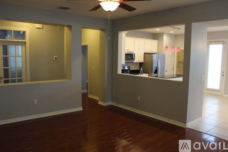 A room with a kitchenette and a refrigerator.