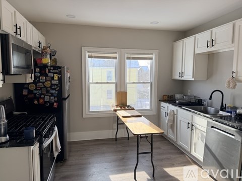 A kitchen with a table and a window.