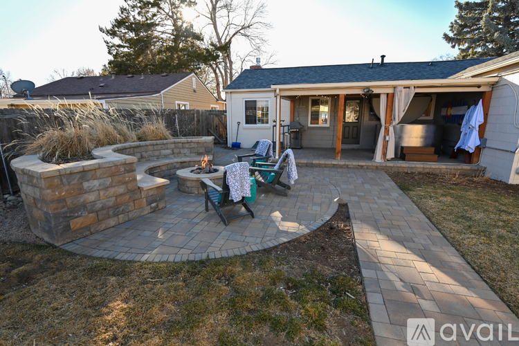 A backyard with a patio and a fire pit.