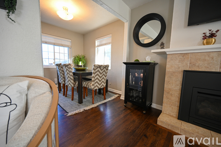 A living room with a fireplace and a mirror on the wall.