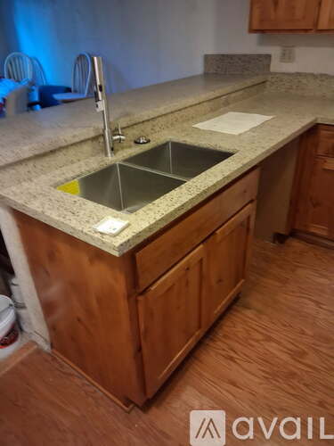 A kitchen island with a sink and a countertop.