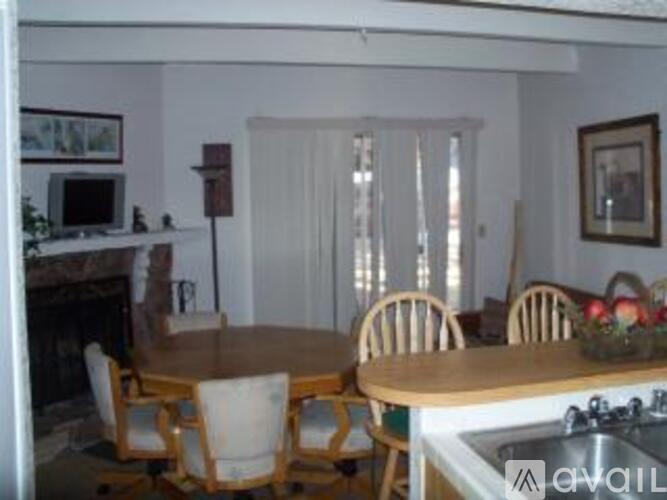 A dining room with a table and chairs.