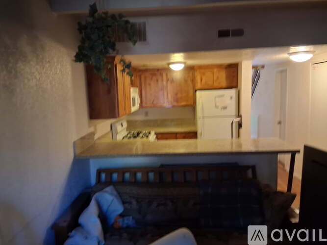 A living room with a couch and a television.