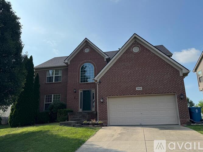 A red brick house with a white garage door.