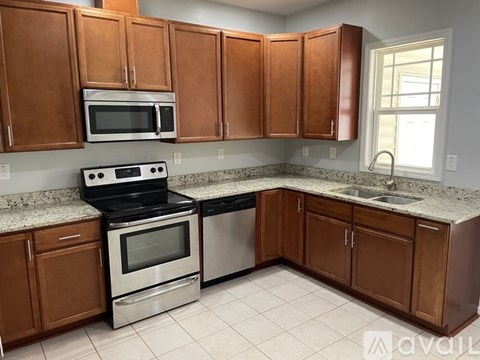 A kitchen with brown cabinets and a white countertop.