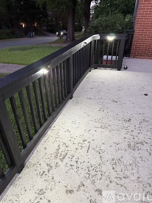 A black metal fence with lights on it.