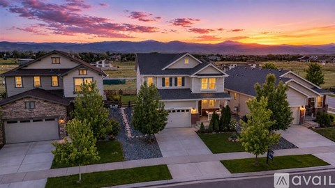 A row of houses with a sunset in the background.