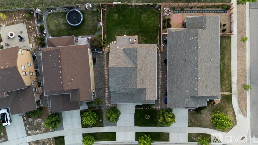 A bird's eye view of a residential area with houses and a playground.