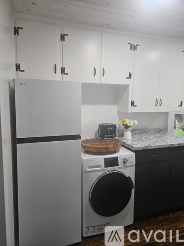A white fridge and washing machine in a kitchen.