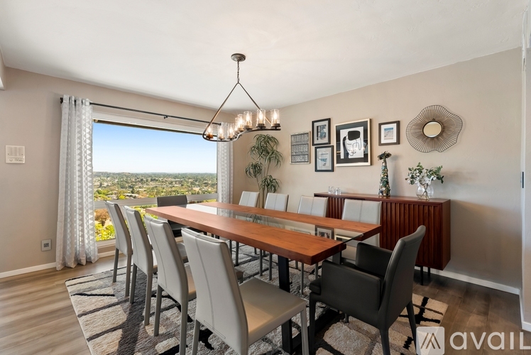 A dining room with a long table and chairs.