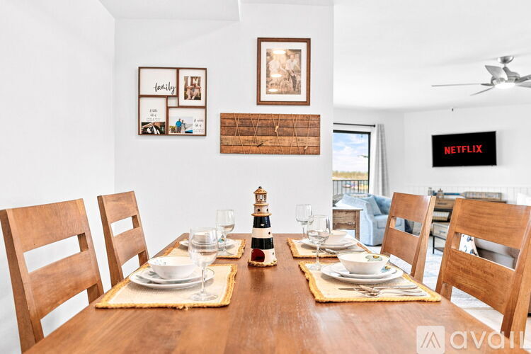 A dining room with a wooden table set for a meal.