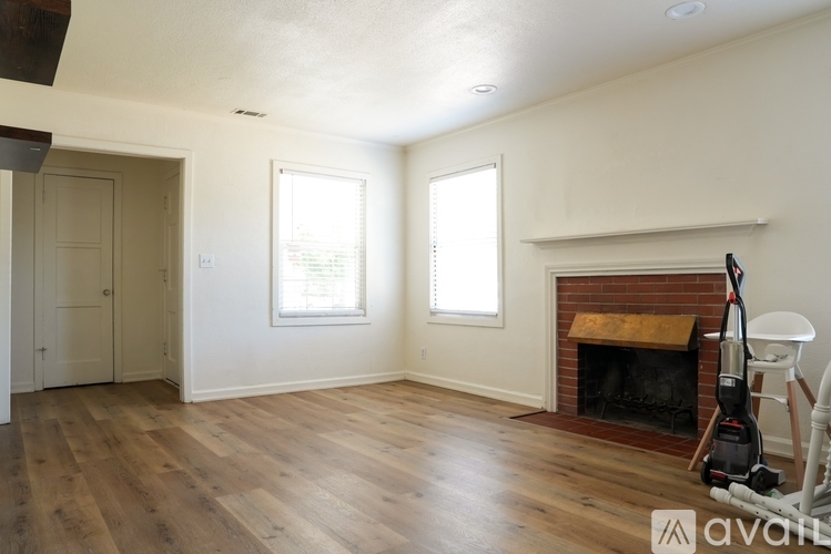 A room with a fireplace and a vacuum cleaner.