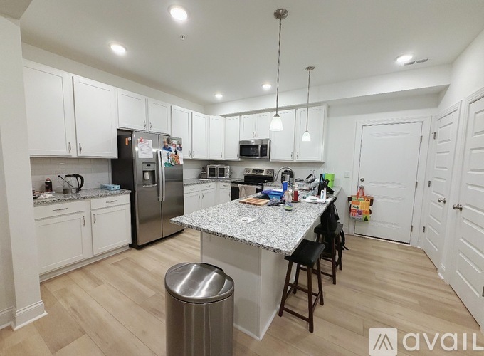 A kitchen with white cabinets and a granite countertop.