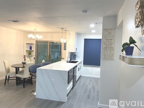 A kitchen with a table and chairs is shown in the image.