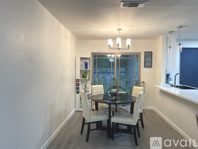 A dining room with a table set for four.