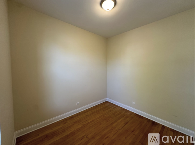 A room with wooden floors and white walls.