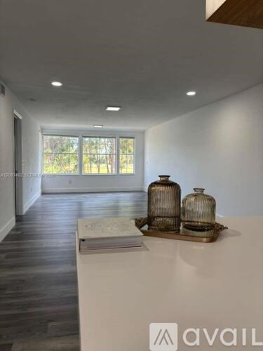 A room with a white table and two vases on it.
