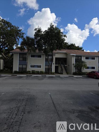 A large building with a parking lot in front of it.