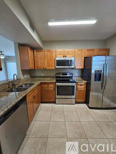 A kitchen with wooden cabinets and stainless steel appliances.