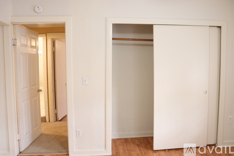 A white door is open to a hallway.