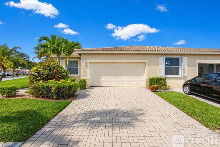 A house with a driveway and a car parked in front.
