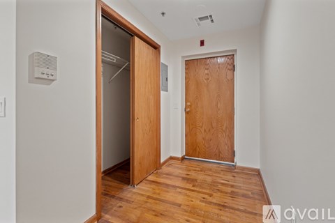 A room with a wooden floor and a wooden door.