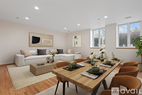 A modern dining room with a wooden table and chairs.