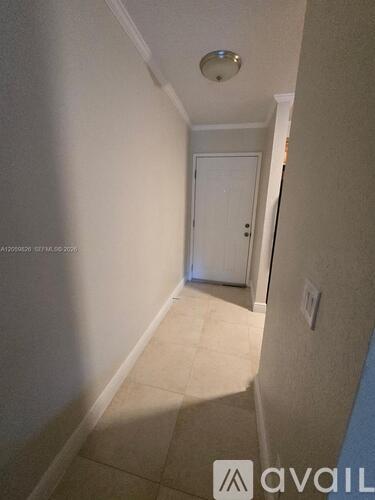 A hallway with a door at the end.