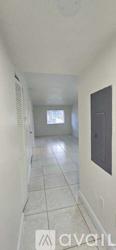 A long hallway with a door on the right side.