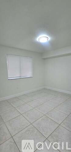 A room with a tiled floor and a window.