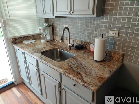 A kitchen with a granite countertop and a sink.