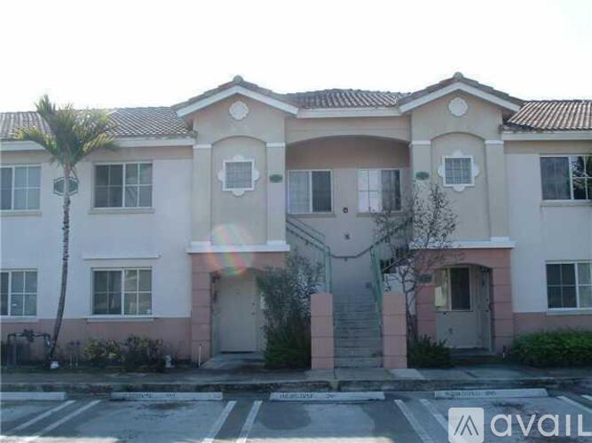 A two-story house with a balcony on the second floor.