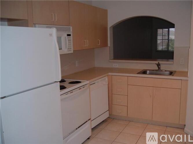 A kitchen with a white refrigerator, white oven, and white microwave.