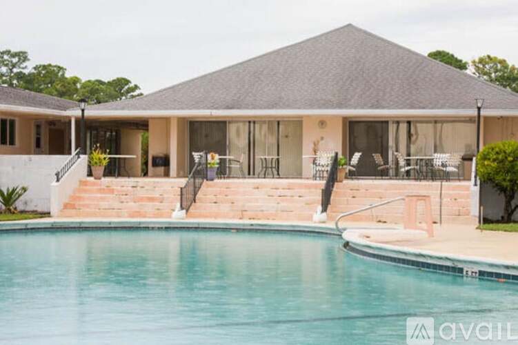 A house with a pool in front of it.