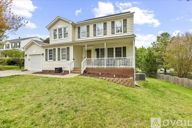 A two-story house with a front porch and a garage.