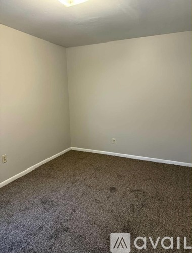 A room with carpeted floor and white walls.