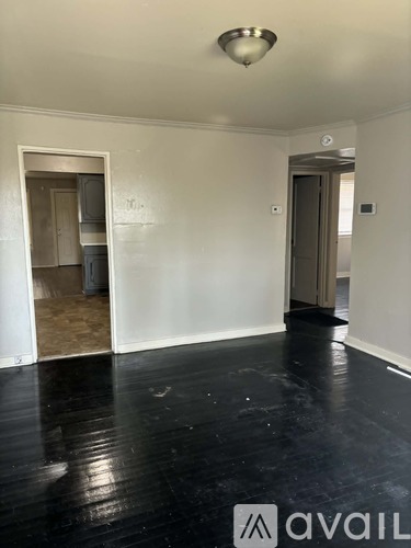 A room with a black floor and white walls.