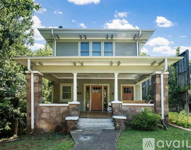 A house with a porch and a front door is for sale.