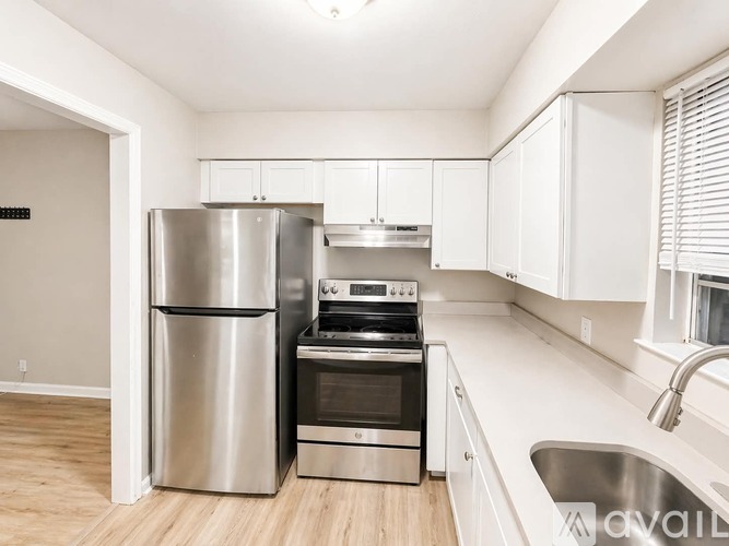 A modern kitchen with stainless steel appliances and white cabinets.