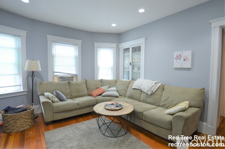 A living room with a grey couch and a coffee table.