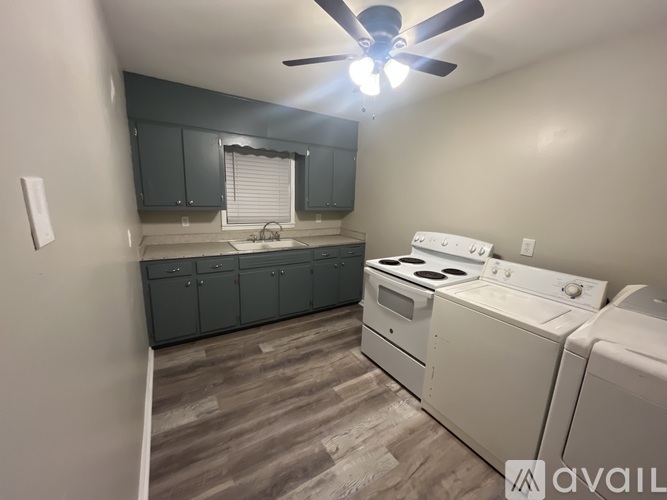 A kitchen with a washer and dryer.