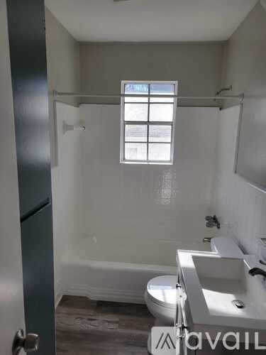 A bathroom with a toilet, sink, and bathtub.