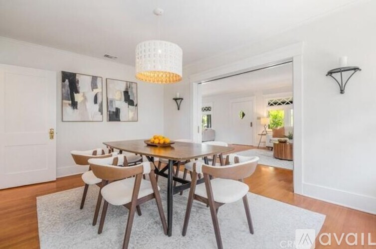 A dining room with a table set for four.